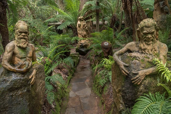 Sculpture of 3 aboriginals at William Ricketts Sanctuary in Mt Dandenong in amongst trees